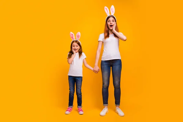 Full length body size view portrait of two nice-looking attractive lovely cheerful cheery childish person having fun holiday weekend isolated over bright vivid shine yellow background — Stock Photo, Image