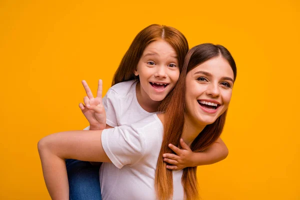 Close-up portrait of two nice-looking attractive lovely cheerful cheery glad playful person having fun free time holiday weekend showing v-sign isolated over bright vivid shine yellow background — Stockfoto