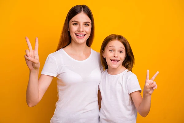 Portrait of two nice attractive lovely funky funny cheerful cheery optimistic glad positive person showing v-sign having fun isolated over bright vivid shine yellow background — Stock Photo, Image