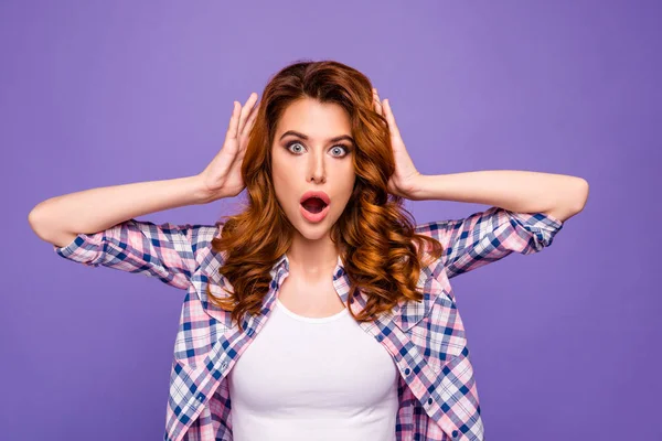 Photo of pretty foxy lady with open mouth and eyes full of fear holding arms on head not believe eyes wear checkered casual shirt isolated purple color background — Stock Photo, Image