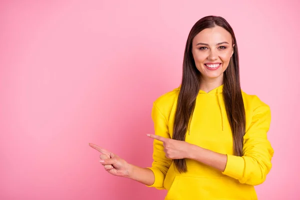Copyspace foto van charmant schattig aantrekkelijk mooi vriendin dragen sportieve kleren glimlachend wijzen op iets wat je moet volgen geïsoleerd met roze pastel kleur achtergrond — Stockfoto