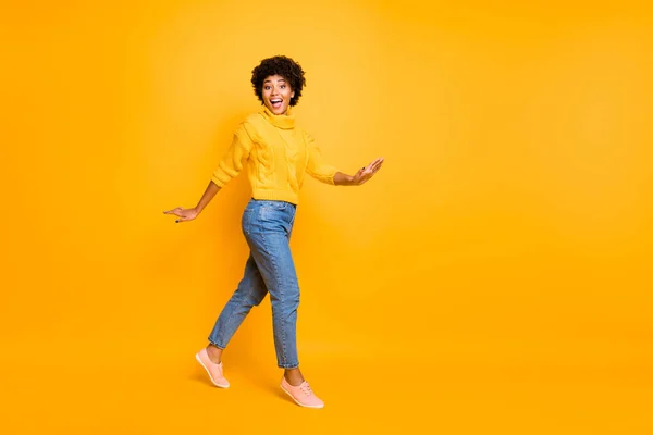 Full length body size view of her she nice attractive charming lovely cute cheerful cheery glad wavy-haired girl walking having fun isolated on bright vivid shine vibrant yellow color background — Stock Photo, Image