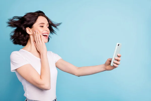 Close-up profile side view portrait of nice attractive lovely amazed cheerful cheery dreamy girl taking selfie having fun isolated on bright vivid shine vibrant blue turquoise color background — Stock Photo, Image