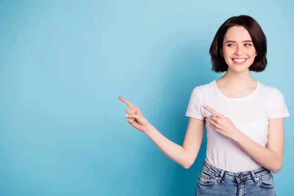 Portrait of her she nice attractive lovely cheerful cheery content girl pointing two forefingers aside ad advert copy blank space isolated over bright vivid shine vibrant blue turquoise color — Stock Photo, Image