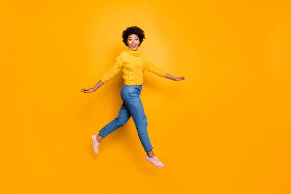 Full length body size photo of cheerful charming cute nice glad girlfriend walking lightly jumping running wearing jeans manim pullover isolated vibrant color background — стоковое фото