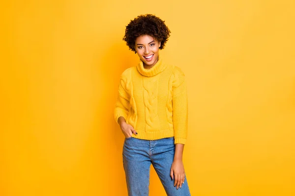 Photo of dark skin funny lady in good mood wear warm knitted pullover and jeans standing isolated yellow background — Stock Photo, Image