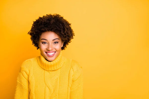 Photo of amazing dark skin lady with sweet beaming smile wear warm knitted jumper isolated yellow background