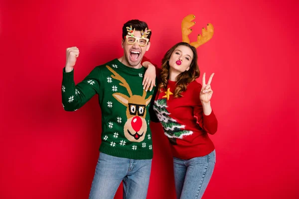Portrait of crazy flirty two family people wife husband brown hair celebrate win wear deer antler costume eyeglasses seasonal christmas tree design clothes denim jeans isolated over red color — Stock Photo, Image