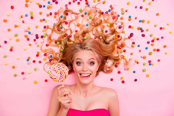 Close up top above high angle view photo amazing she her lolly pop lollypop hand arm lady lying down sweets ideal hair tongue out mouth crazy wearing dress isolated rose pink background — Stock Photo, Image