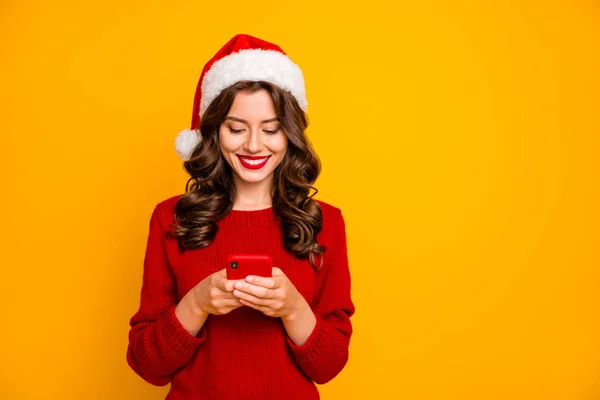 Photo of amazing lady holding telephone in hands wear knitted pullover and santa hat isolated yellow background — Stock Photo, Image