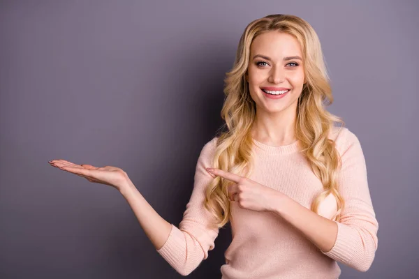 Portrait of her she nice attractive cheerful cheery glad positive content wavy-haired girl pointing forefinger holding invisible object isolated over gray violet purple pastel color background — ストック写真