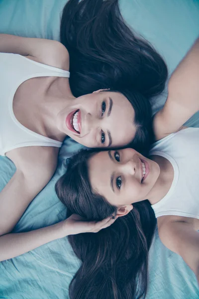 Self-portrait of two nice beautiful attractive lovely sweet charming cute feminine careful cheerful cheery brunette people spending free spare time holiday leisure upbringing lying on blue linen — Stock Photo, Image