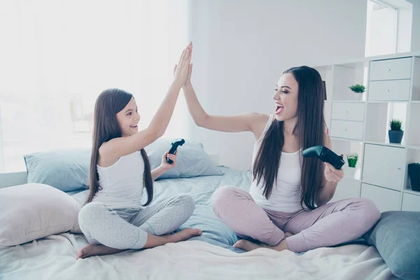 Portrait of two nice beautiful attractive lovely long haired cheerful glad excited positive people best friends celebrating battle win deal done agree good job in light white interior room indoors — 스톡 사진