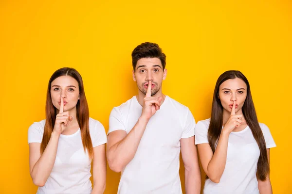 Portrait of three nice attractive lovely winsome person showing shh sign secrecy privacy isolated over bright vivid shine yellow background — Stock Photo, Image