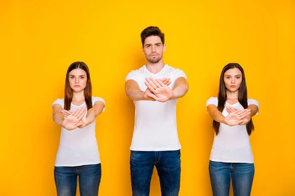 Portrait of strict mates crossing palms wearing white t-shirt denim jeans isolated over yellow background — Stock Photo, Image