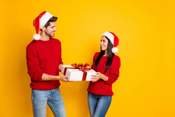 Profile side photo of charming two married people get give packages wear red pullover denim jeans isolated over yellow background — Zdjęcie stockowe