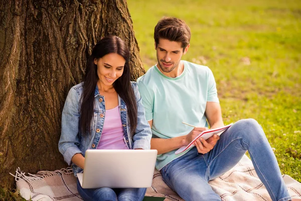 Portrait of her she his he nice attractive smart clever cheerful cheery focused friends preparing homework task writing essay article subject project sitting on veil cover outside — Stock Photo, Image