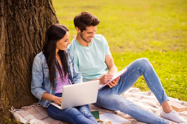 Her she his he attractive lovely charming cheerful cheery married spouses studying preparing homework task writing exercise sitting on veil cover grass springtime outside — Stock Photo, Image