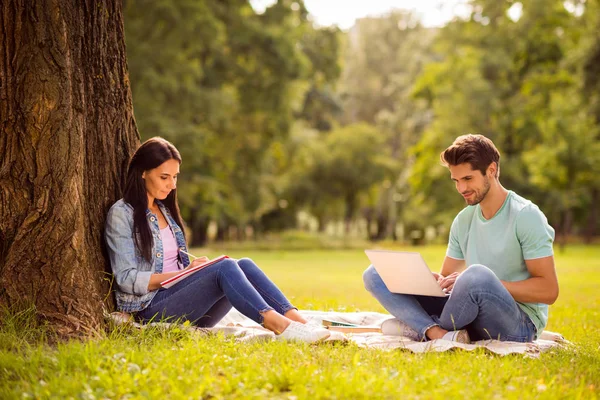 Her she his he attractive lovely charming cheerful smart clever married spouses studying preparing homework sitting on veil cover grass springtime outside