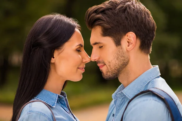 Profile photo of amazing pair going to kiss contacting noses closing eyes wear denim outfit — Stock Photo, Image