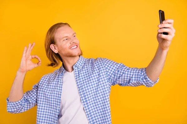 Neşeli sevimli güzel eğlenceli pozitif funky adam blogger konuşma video arama konuşma fotoğraf diş dama mavi gömlek parlak renk sarı arka plan üzerinde izole selfie alarak giyen gülümseyerek — Stok fotoğraf
