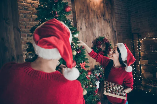 상록 크리스마스 트리를 장식 하는 baubles를 들고 두 낭만적 인 사람들의 뒷면 사진 실내 에서 새해 장식 조명 집에서 x-mas 휴일을 즐길 수 있습니다. — 스톡 사진
