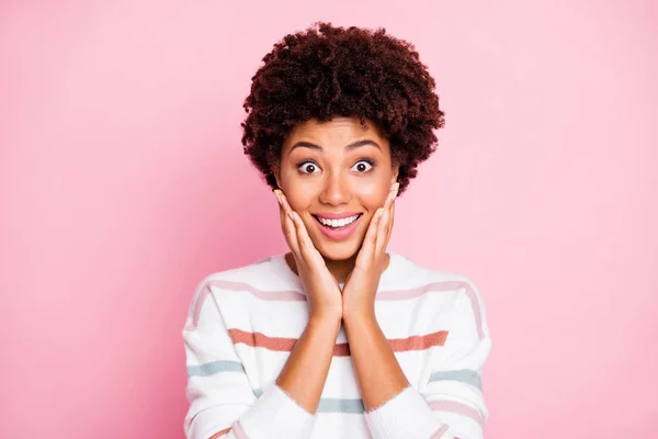 Photo of funny dark skin lady in best mood listen news about black Friday shopping arms touch cheekbones wear white striped pullover isolated pink color background — Zdjęcie stockowe