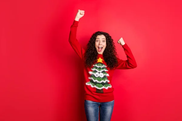 Wow unbelievable newyear party. Portrait of crazy funny funky girl raise fists scream yeah celebrate x-mas wear traditional seasonal clothes with christmas tree decor isolated red color background — Stock Photo, Image