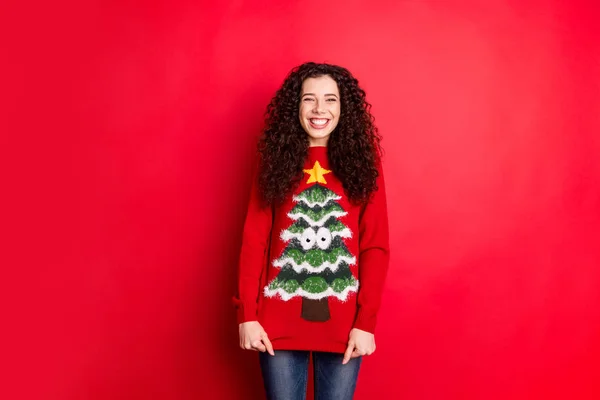 Portrait of funny funky cheerful positive girl get seasonal comfy sweater jumper with stylish trendy christmas tree decor for x-mas newyear gift isolated over red color background — Stock Photo, Image