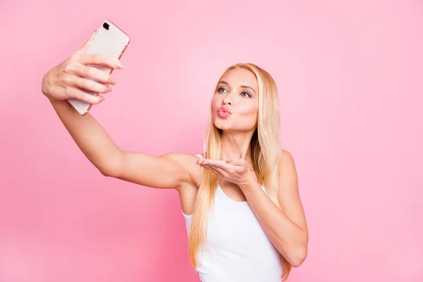 Portrait of charming lovely positive girl influencer take selfie send air kisses travel on trip wear sporty outfit good look isolated over pink color background — Stock Photo, Image