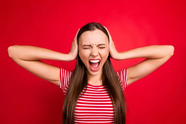 Foto van geïrriteerde vrouw trendy dragen gestreepte t-shirt schreeuwen in pijn terwijl geïsoleerd met rode achtergrond — Stockfoto