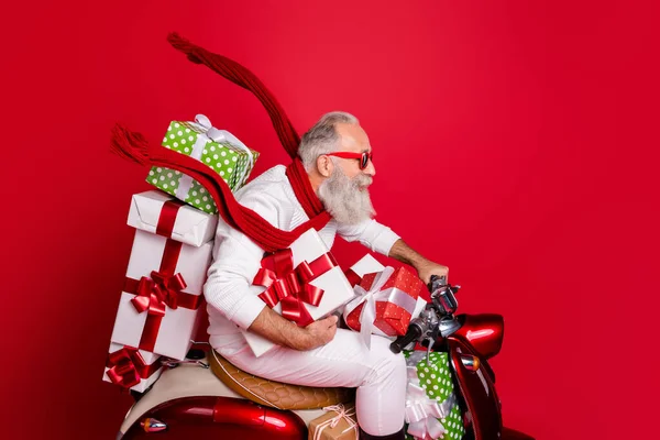 Profile side view of his he nice funny funky gray-haired bearded man riding moto delivering stack desirable purchase air wind blow kerchief isolated over bright vivid shine red background — Stockfoto