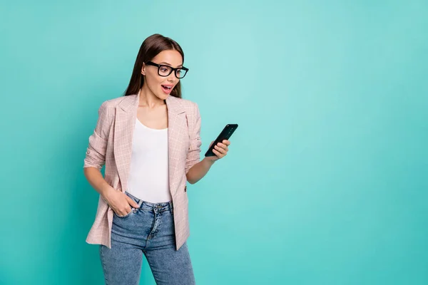 Portrait of her she nice attractive pretty smart clever intelligent cheerful straight-haired lady using gadget browsing isolated over bright vivid shine blue green teal turquoise background