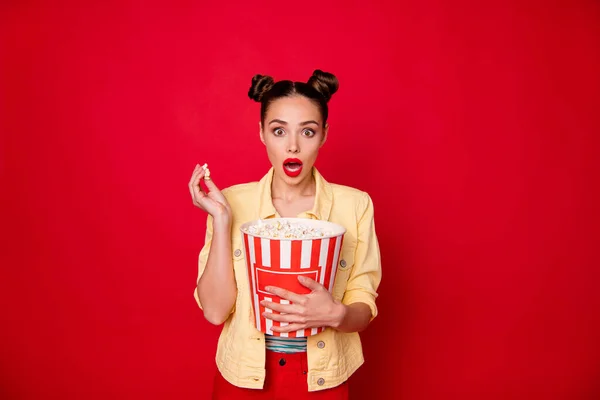 Senhora bonita segurando recipiente pipoca assistindo horror filme desgaste casual roupa isolado fundo vermelho — Fotografia de Stock