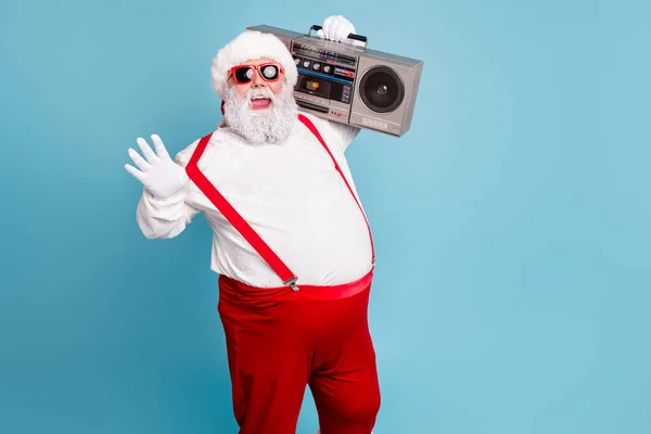 Portrait of nice bearded cheerful funky funny glad big belly Santa carrying tape player having fun isolated over bright vivid shine vibrant blue turquoise color background — Stock Photo, Image