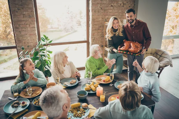 Photo of full family sit feast dishes table meet amazing big roasted turkey ovations clap arms wife husband multi-generation relatives annual event in living room indoors — Stock Photo, Image