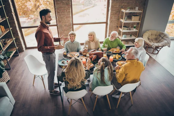 Photo of full big family gathering sit feast meals dinner table father guy tell thanksgiving pray toast multi-generation eight members in evening living room indoors — Stock Photo, Image
