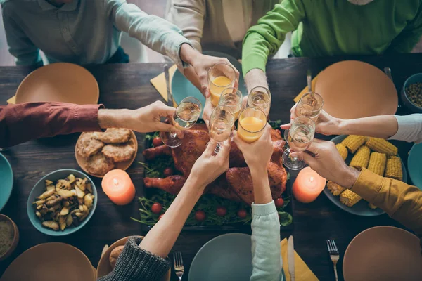 Cropped view of nice big full family brother sister couples clinking glass orange juice beverage over served table meal dishes generation meeting day in house restaurant catering — Photo