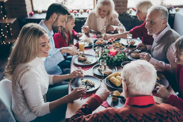 Photo of full family gathering sitting around dinner table communicating x-mas party tradition all together son daughter grandma grandpa in noel decorated living room indoors — Stock Photo, Image