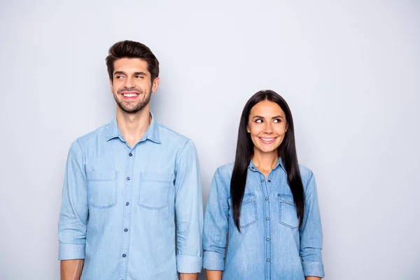 Photo of cute cheerful brown haired charming couple of spouses feeling awkward smiling toothily wearing jeans denim isolated over grey color background — Stock Photo, Image