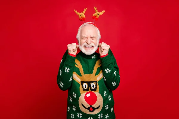 Photo of funny santa man with pretty horns on head celebrating newyear surprise visit from children wear stylish x-mas ugly ornament sweater isolated red background — Stock Photo, Image