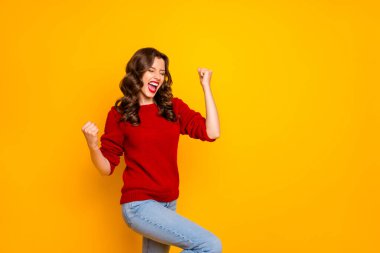 Photo of trendy cheerful charming nice fascinating girlfriend wearing jeans denim making fists rejoicing with victory isolated over vivid color background clipart