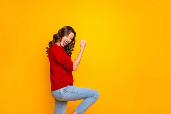Copyspace photo of curly trendy cheerful charming attractive overjoyed girlfriend celebrating victory of her team wearing jeans denim isolated with vivid yellow color background — Stock Photo, Image
