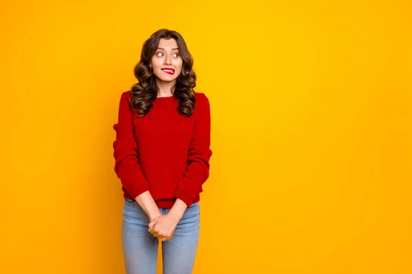 Photo of pretty curly wavy charming cute cheerful nice good girlfriend standing hesitating and shy looking away at something with hands folded isolated over yellow vivid color background — Stock Photo, Image