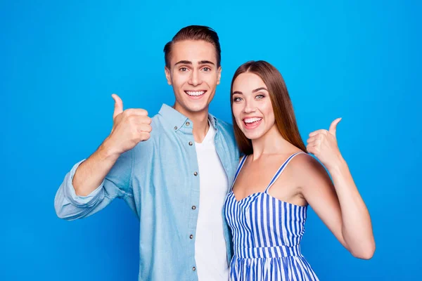 Close-up portrait of his he her she two nice attractive lovely content cheerful cheery glad people embracing showing thumbup isolated over bright vivid shine vibrant blue color background — Stock Photo, Image
