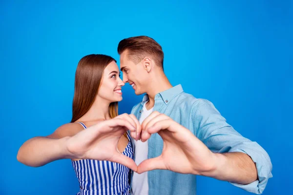 Close-up portrait of her she his he two nice attractive charming cheerful cheery tender people showing giving heart shape cuddling isolated over bright vivid shine vibrant blue color background — Stock Photo, Image