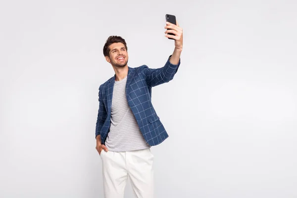 Portrait of his he nice attractive lovely stylish cheerful cheery freelancer busy body wearing blue checked blazer taking making selfie isolated over light white pastel background — ストック写真