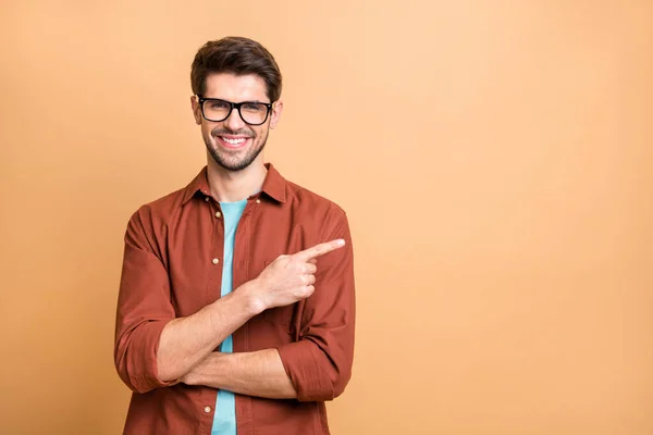 Close-up portrait of his he nice attractive cheerful cheery glad successful content brunet guy pointing forefinger aside advice advert solution isolated over beige color pastel background — ストック写真