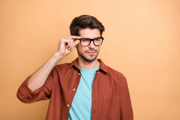 Close-up portrait of his he nice attractive serious successful smart clever intelligent brunette guy touching specs isolated over beige color pastel background — Stock Photo, Image
