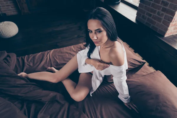 Portrait of her she nice-looking gorgeous attractive lovely lovable pretty girl sitting on bed bare foot teasing you undressing at industrial brick wood loft modern interior style flat hotel indoors — Stock Photo, Image